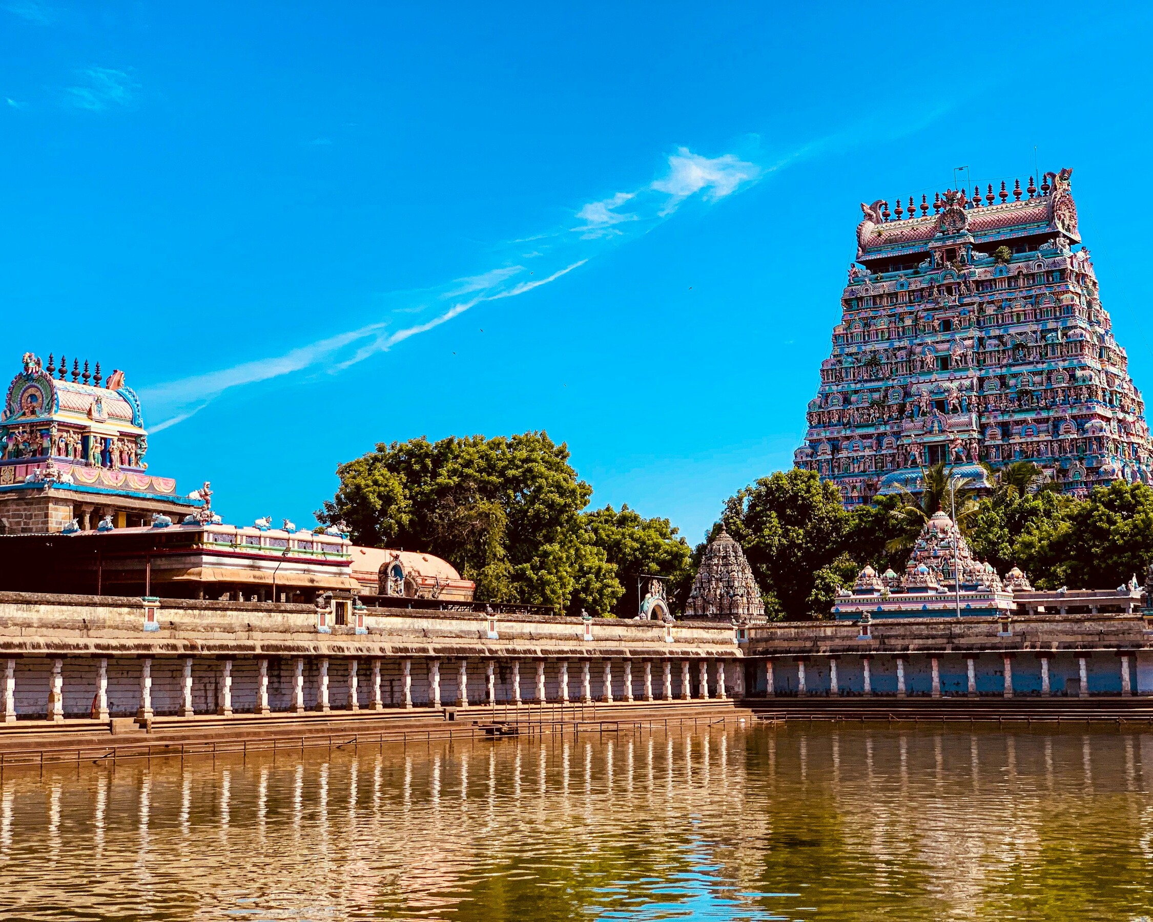 View of the intricate gopuram of Meenakshi Temple in Madurai, adorned with colorful sculptures.