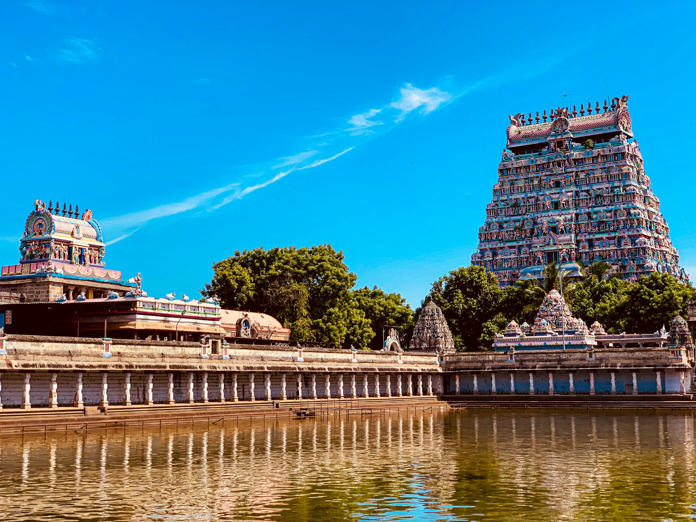 View of the intricate gopuram of Meenakshi Temple in Madurai, adorned with colorful sculptures.