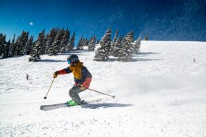 Skier gliding down snow-covered slopes in Gulmarg, Jammu & Kashmir during winter