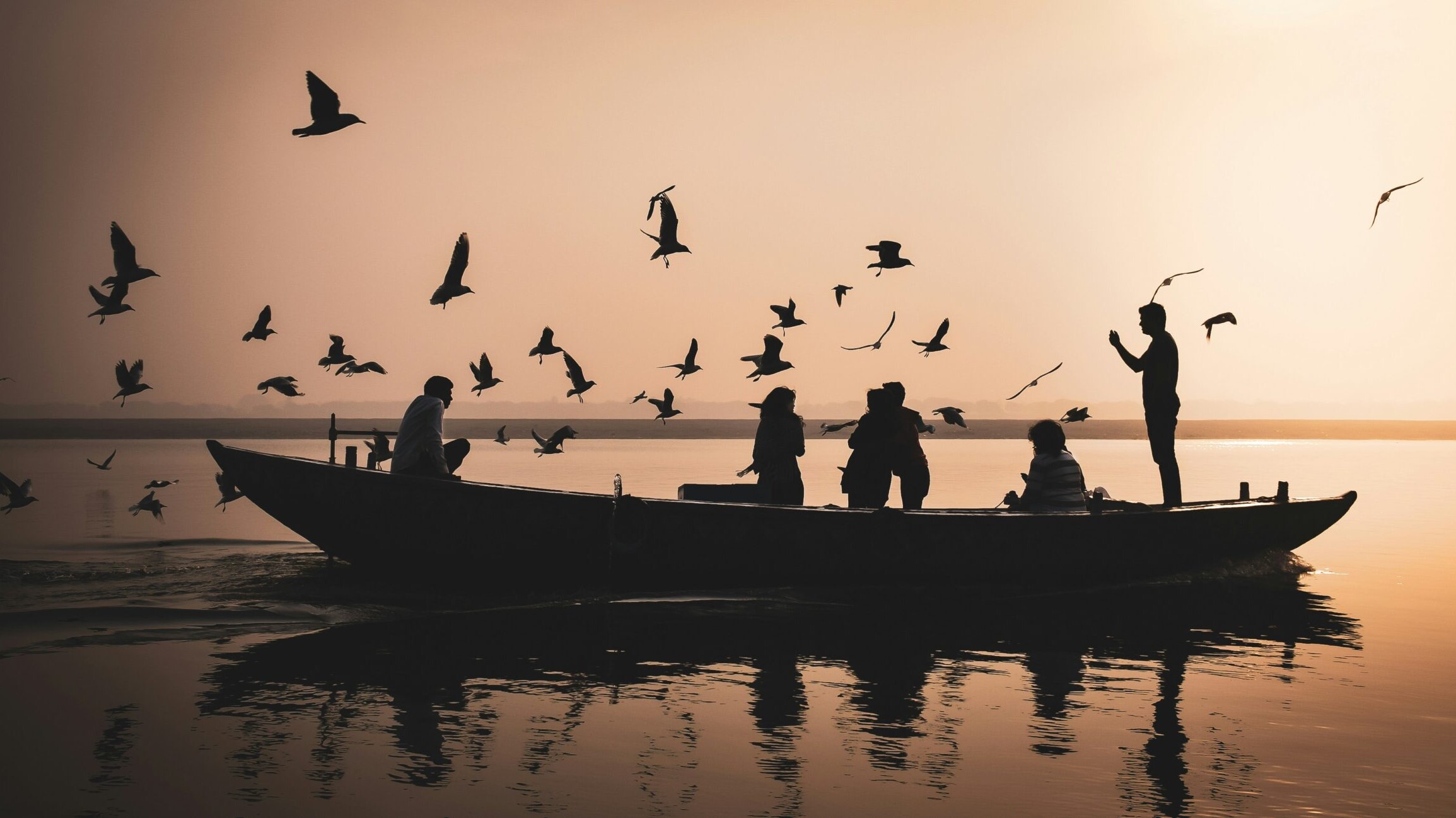 Morning view of Assi Ghat with priests performing rituals, golden light on the water