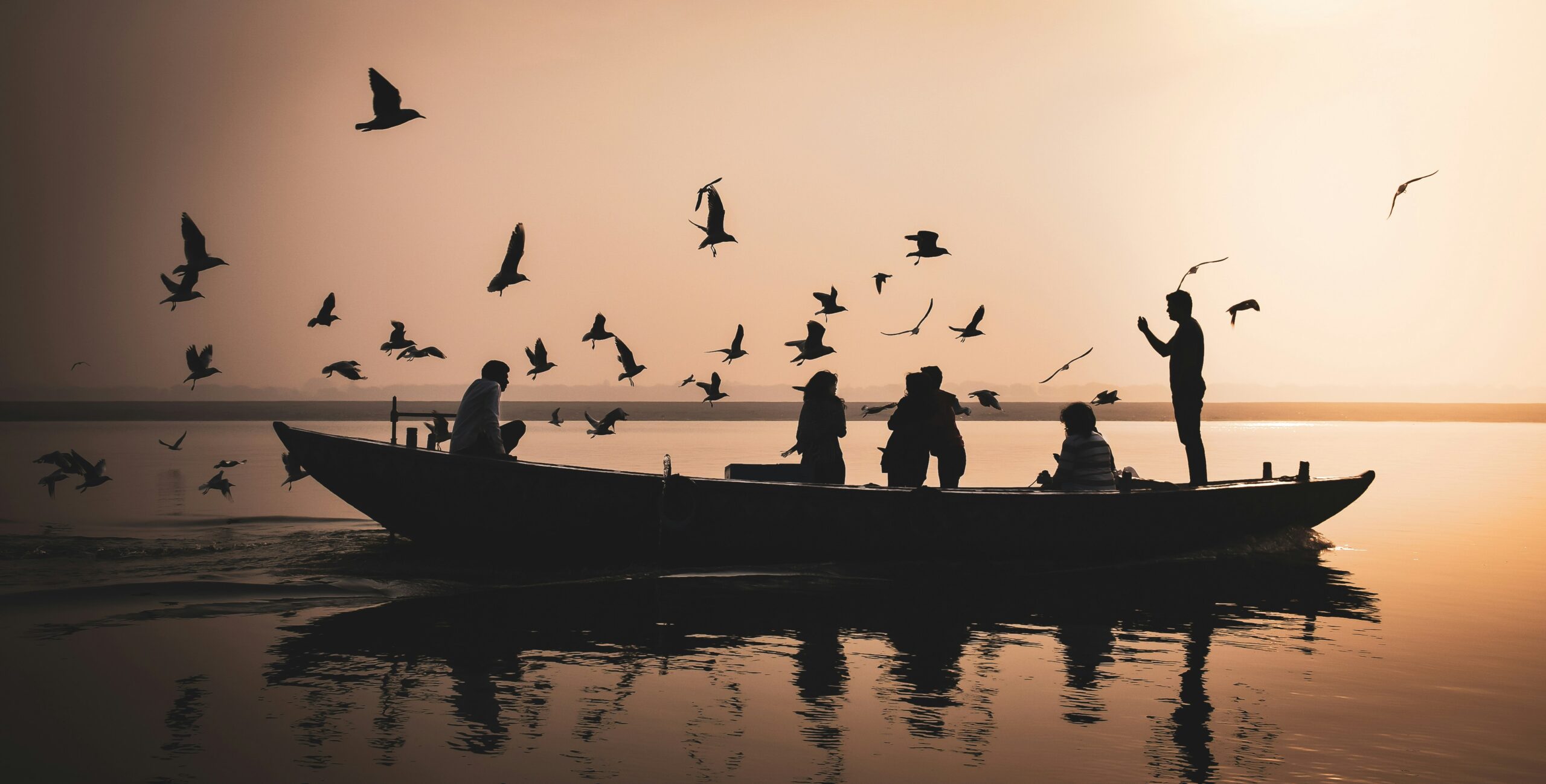 sergio capuzzimati Lr0dNUWVLrE unsplash scaled - Divine Varanasi Sunrise Boat Ride – A Foreigner’s Complete Guide Morning view of Assi Ghat with priests performing rituals, golden light on the water
